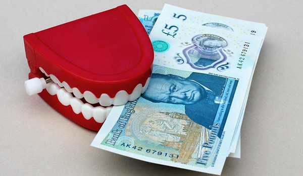 money held between a pair of teeth
