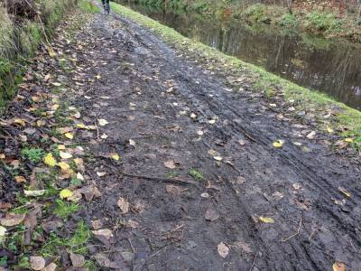 A very muddy path with the canal running down the right hand side