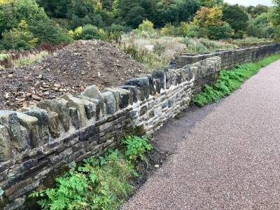 Stone wall rebuilt and repaired.