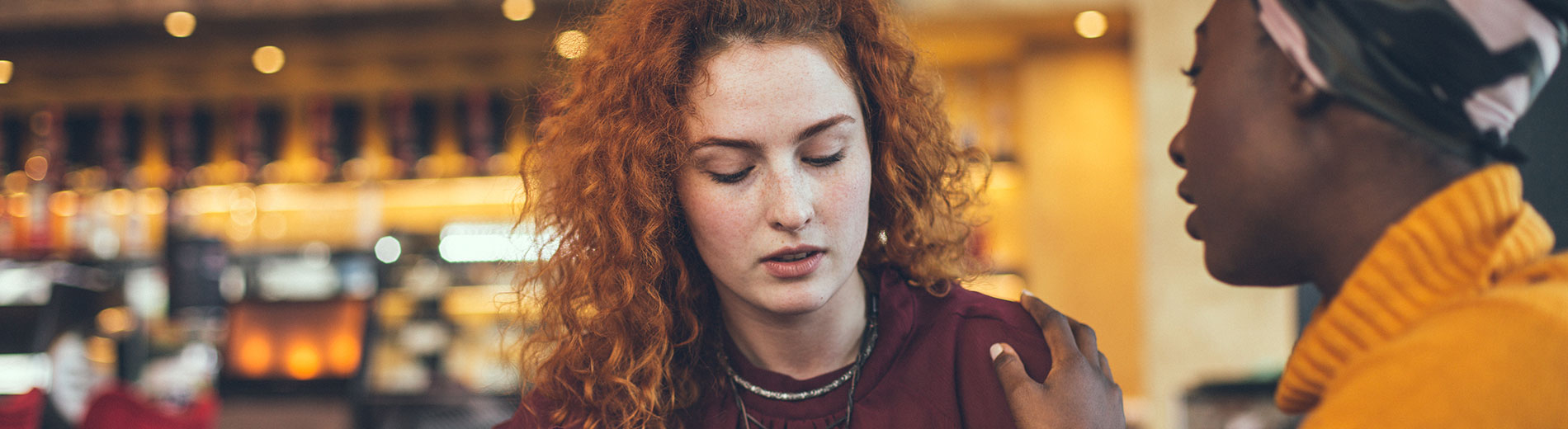 Hands holding a paper cutout of a woman, a man and two children