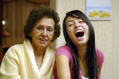 A grandma and a young woman laughing together