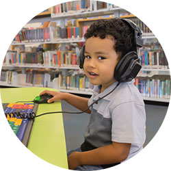 Boy with headphones on computer
