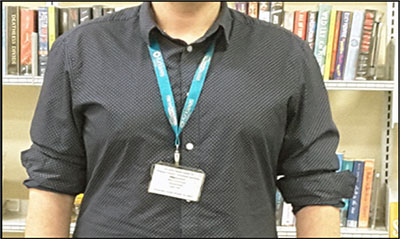 A library employee, with their identification card on a lanyard