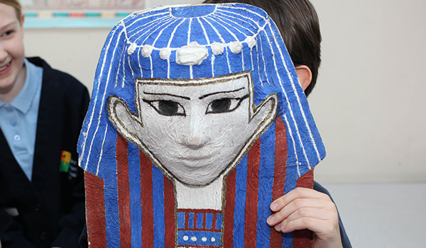 A child holding a mummy mask