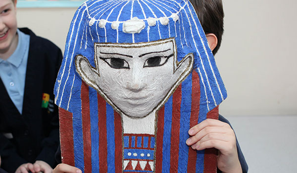 A child holding a mummy mask