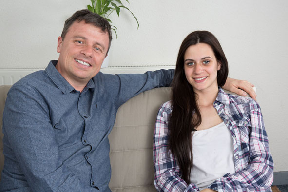 Man and woman sat down on seats