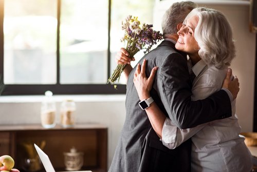 Couple hugging with flowers