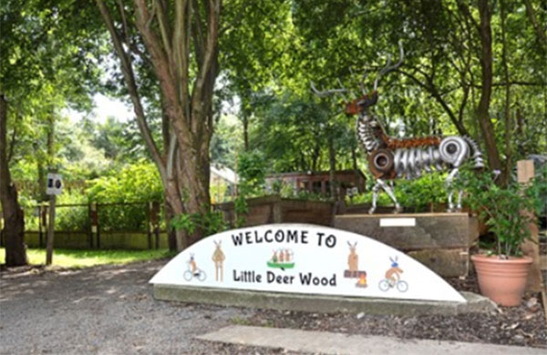 Front view of Little Deer Wood activity centre showing the sign