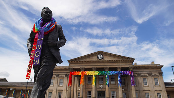 Kirklees train station behind a knitted scarf over the statue of Harold Wilson