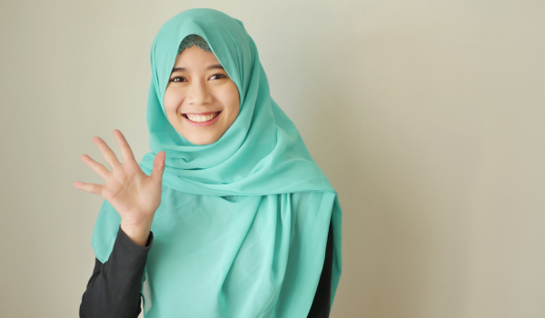 A foster carer smiling and waving