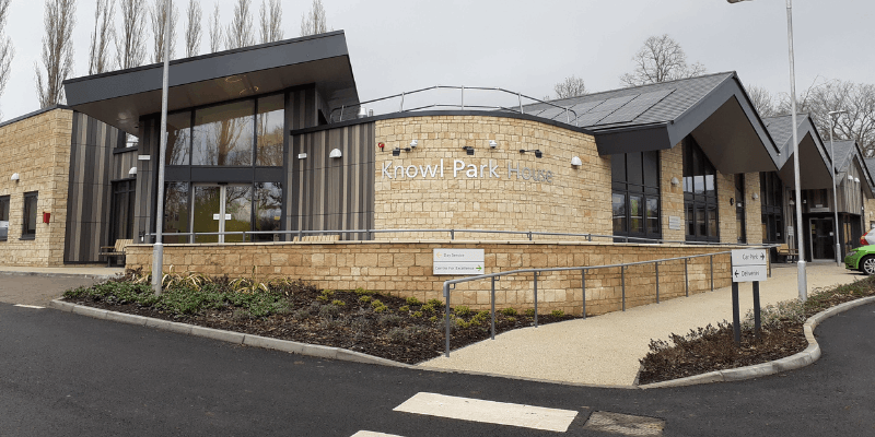 Main building at Knowl Park House, in light stone with large windows