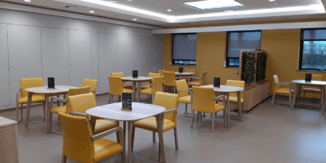 Dining area at Knowl Park House, with yellow chairs around each table