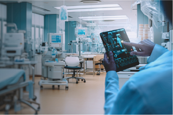 A health worker holding a tablet device and pressing buttons on it