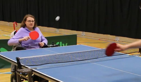 Two people playing table tennis