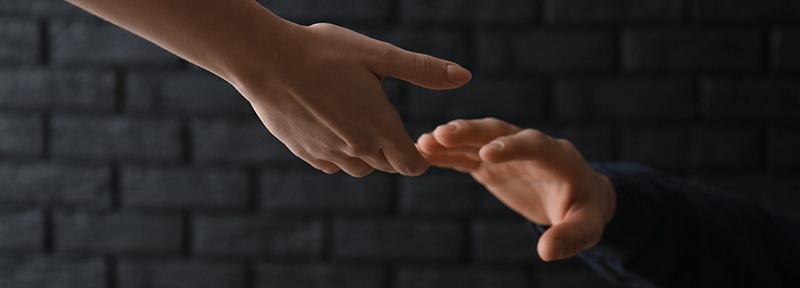 Hands reaching towards each other
