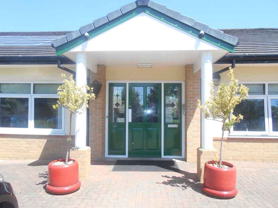 The portico entrance to Mill Dale on a sunny day