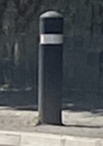 Black bollard with a white reflective stripe around the top
