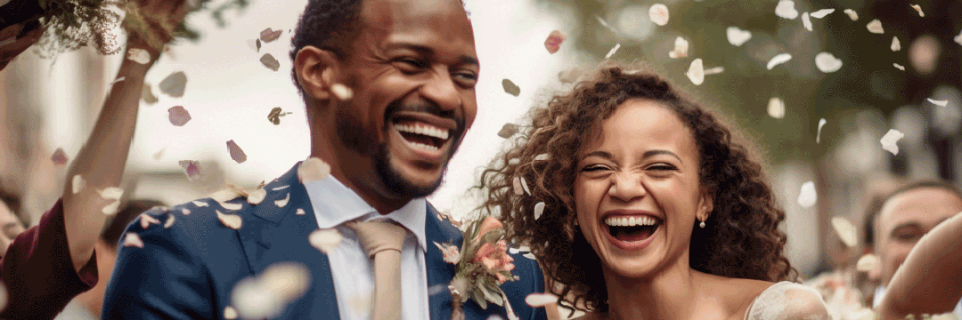 Photo of a couple laughing with confetti being thrown
