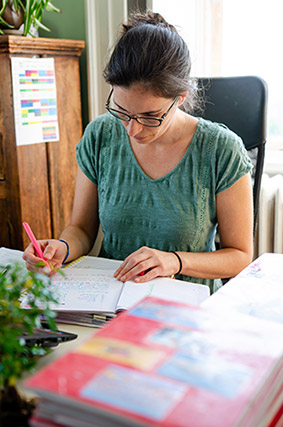 Teacher writing at their desk