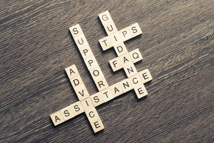 Scrabble game spelling out support and assistance