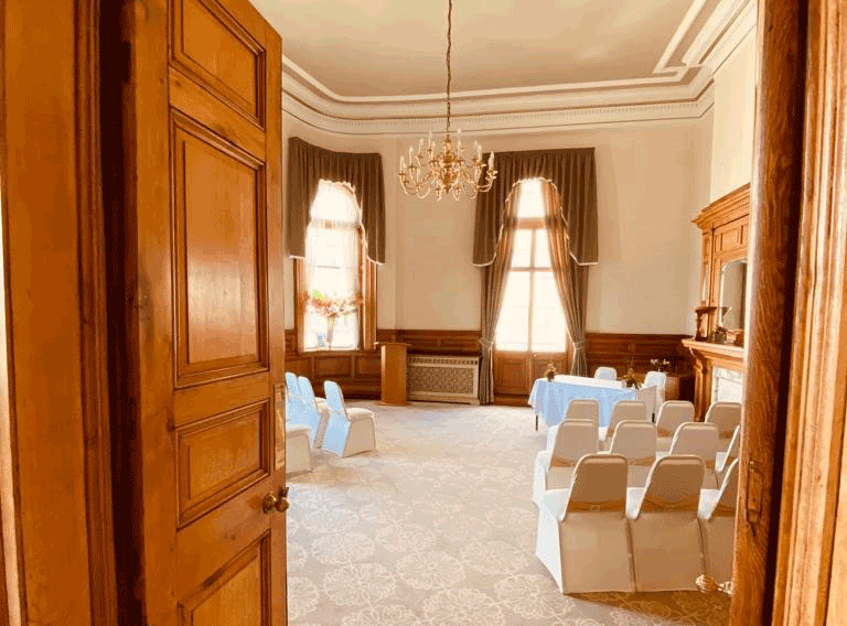 Decorated Dewsbury Town Hall Ceremony Room with white chairs in rows